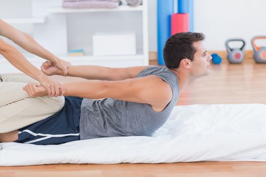 Man stretching with his trainer