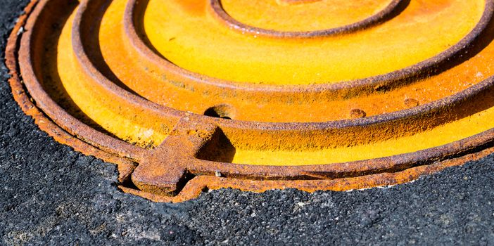 Rusty metal manhole cover