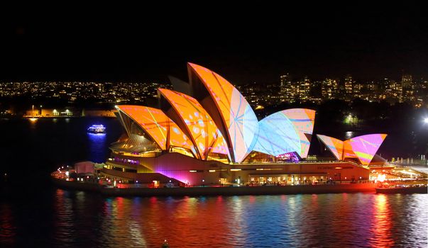 Sydney Opera House in bright patterns of orange and blue Vivid S