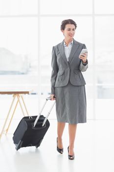 Businesswoman text messaging while on a business trip