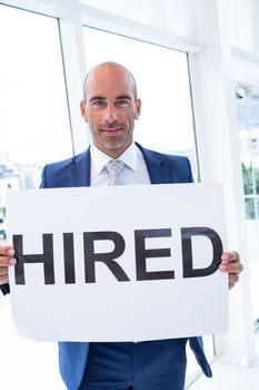 businessman holding a hired sign