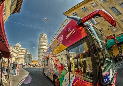 PISA, ITALY - MAY 12, 2014: Sightseeing bus in Square of Miracles. Pisa is visited by 3 million people annually.