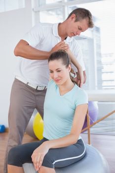 Woman stretching her arm with trainer