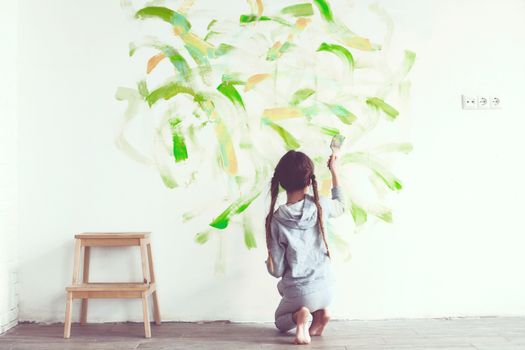 Child painting wall