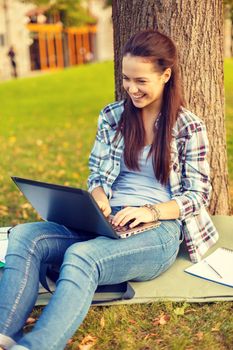 smiling teenager with laptop