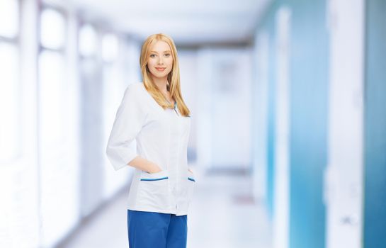 smiling female doctor or nurse in medical facility