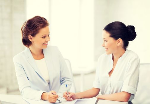 two businesswomen having discussion in office