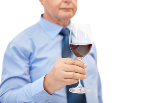 close up of senior man holding glass with red wine