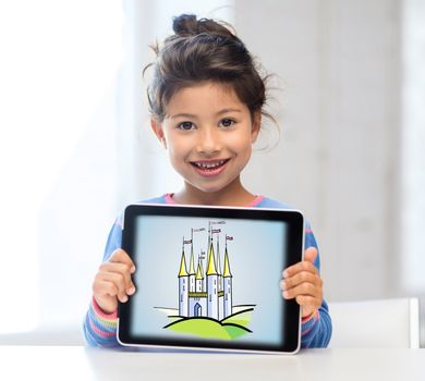 little girl showing castle on tablet pc screen