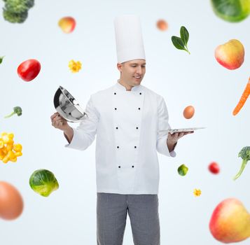 happy male chef cook opening cloche