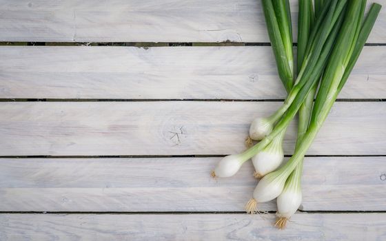 Scallions on a wooden table