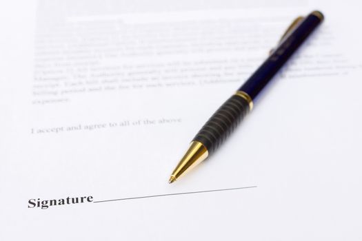 Pen for signature lying on contract