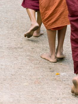 Foots of ascetic Buddhist monk walking at the way to  Kyaikhtiyo
