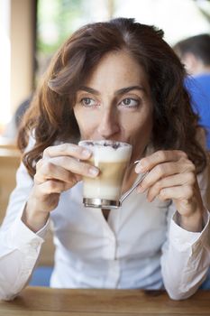 woman drinking cappuccino coffee