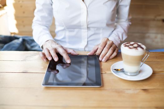 woman using tablet in cafe