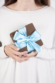 woman taking brown and blue gift