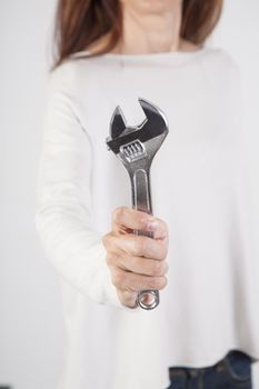 wrench in woman hand