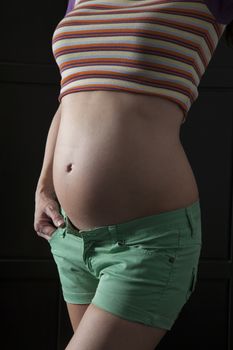 pregnant woman on dark background