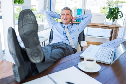 Businessman relaxing in a swivel chair 