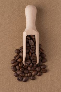 Wooden scoop with coffee beans