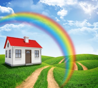House on green field with rainbow