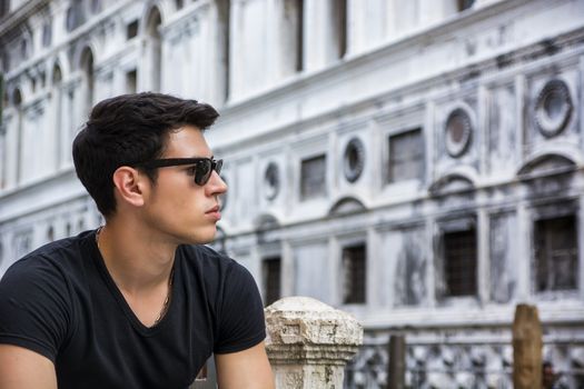 Young Man on Bridge Over Narrow Canal in Venice