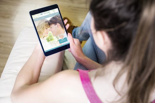 Composite image of woman using tablet at home