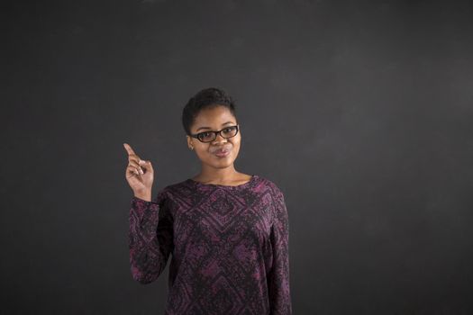 African woman good idea on blackboard background