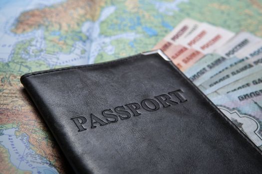 passport in the bag on a map with bank notes