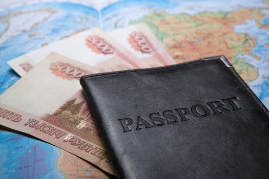 passport in the bag on a map with bank notes