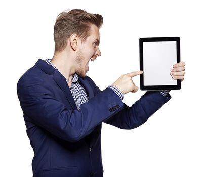 Angry young man pointing at tablet PC