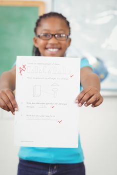 Proud pupil showing test result to camera