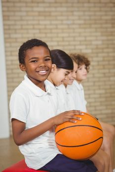 Student holding basketball with fellow players