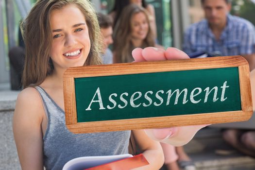 Assessment against pretty student smiling at camera outside