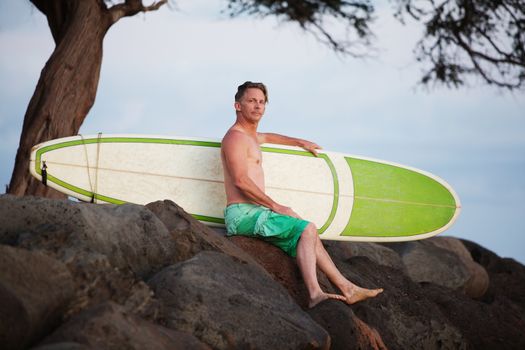 Man Sitting with Surfboard