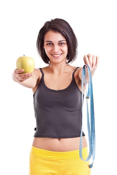 Woman holding apple and measuring