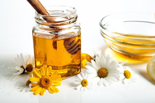 Still life of honey, tableware, flowers, nuts, close up