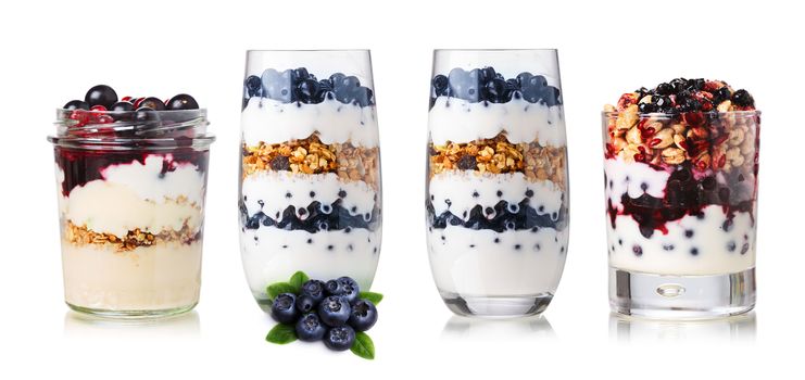 Collection of parfait desserts or snacks in glasses and jars. American parfait with muesli,granola,yogurt,puffed wheat,fresh berries and jam
