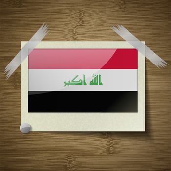 Flags Iraq at frame on wooden texture. Vector