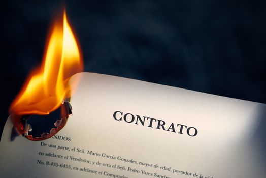 Closeup of sale agreement in Spanish burning. Concept shot of freedom and new beginnings