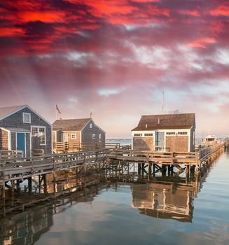 Wooden Homes over water at sunset.