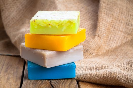 colorful handmade soap bars, on wooden background