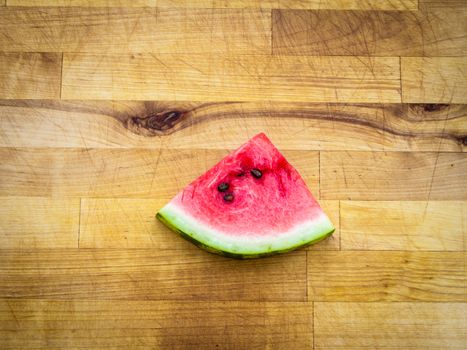 Watermelon slice arranged on a wooden board
