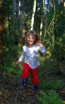 Running little girl in the forest