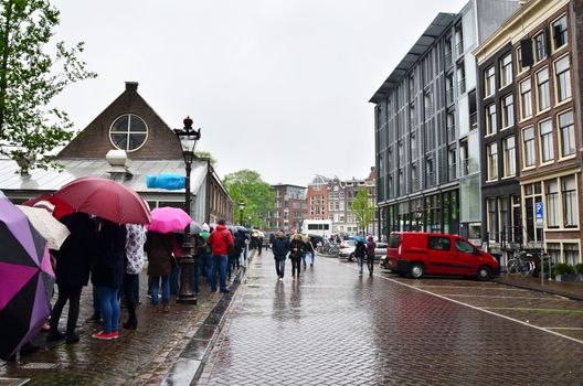 Amsterdam, Netherlands - May 16, 2015: People queuing at the Anne Frank house and holocaust museum in Amsterdam