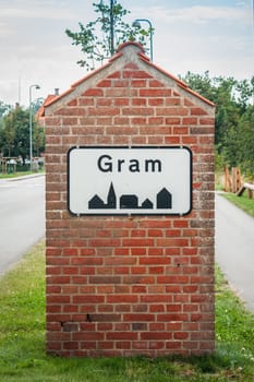 Gram city sign on a brick post