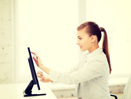 smiling businesswoman with touchscreen in office