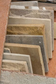 stack of various granite marble tiles on ground