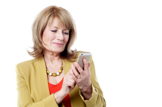 Mature woman dialing on a smart phone 