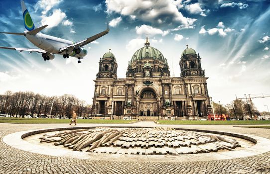 Airplane overflying Berlin Cathedral